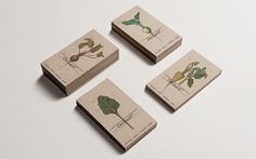 four business cards with different types of vegetables on them, all printed in brown paper