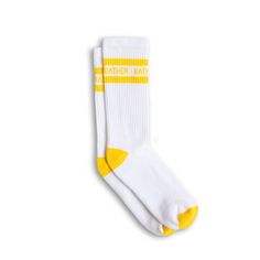 White Bather crew socks with two yellow stripes and text logo around ankle Comfortable Sports Socks For Spring, Comfortable Cotton Knee-high Socks For Spring, Sporty Stretch Cotton Socks, Casual Summer Streetwear Socks, Comfortable Cotton Knee-high Socks, Sporty Cotton Knee-high Socks, Sporty Stretch Cotton Knee-high Socks, Stretch Cotton Knee-high Sporty Socks, White Cotton Knee-high Socks