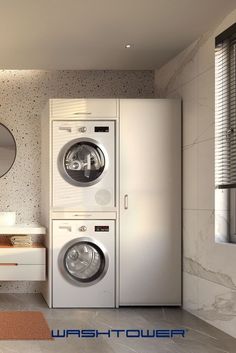 a washer and dryer in a bathroom with a mirror on the wall above it