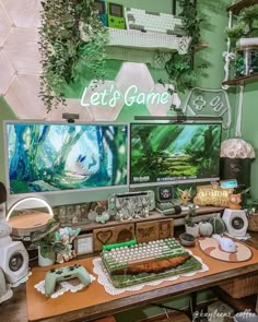 a desk with two computer monitors on top of it next to plants and other items