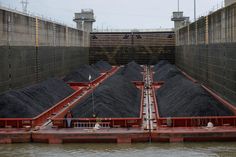 a large amount of coal is being loaded into the water