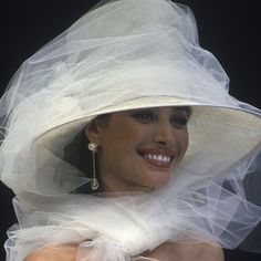 a woman wearing a white hat and veil