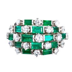 A fine diamond and emerald cocktail ring. Contains 19 round brilliant diamonds and 14 rectangular step cut emeralds set in platinum. Diamonds are ~2.30 ctw. Emeralds are ~3.50 ctw. Currently size 5-1/2 US and complimentary resizing from 3.5 - 8 US. No. 6630 Emerald And Diamond Band, Gemstone Wedding Ring, Round Cut Diamond Ring, Emerald Ring Vintage, Gemstone Wedding Rings, Vintage Jewlery, Platinum Diamond Rings, Green Room, Wedding Rings Vintage