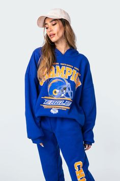 Get the oversized look with this champion graphic hoodie. This cozy drop shoulder sweatshirt is constructed from a soft flock fabric and features ribbed cuffed sleeves to lock in the warmth. Blue Sweats For Streetwear During Sports Season, Blue Athleisure Sweatshirt With Graphic Print, Blue Graphic Print Athleisure Sweatshirt, Blue Graphic Print Sweatshirt Sportswear, Blue Hooded Sweats For Streetwear, Blue Athleisure Sweats With Letter Print, Blue Sporty Sweats With Letter Print, Blue Sporty Sweats For College, Sporty Blue Sweats For Sports Season