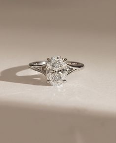 a diamond ring sitting on top of a white surface