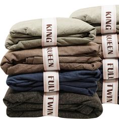 five folded linens stacked on top of each other with the words king and queen printed on them