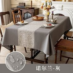 a dining room table covered with a gray tablecloth