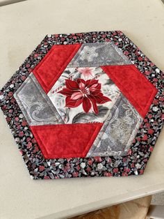 a close up of a red and black patchwork design on a white table top