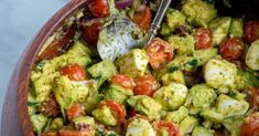 a bowl filled with lots of different types of food on top of a white table