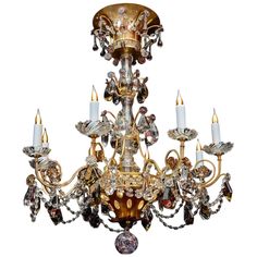 a fancy chandelier with many lights on the top and bottom, including candles