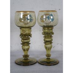 two glass goblets sitting on top of each other