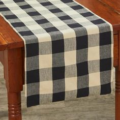 a black and white checkered table runner on a wooden table