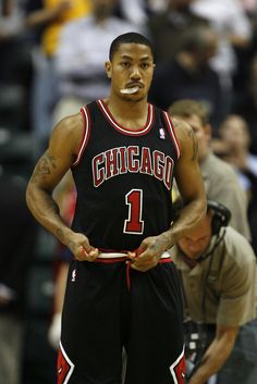 a basketball player standing on the court with his hands in his pockets