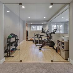 a home gym with mirrors and exercise equipment