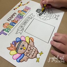 a child's hand writing on a thanksgiving coloring page