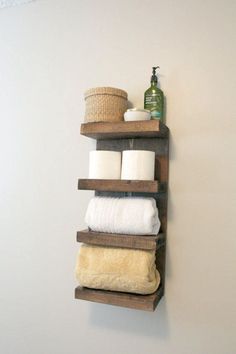 a shelf with towels, soaps and a basket on it