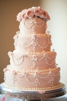 a three tiered cake with pink flowers on top