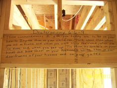 a wooden structure with writing on it in the process of being framed by wood framing