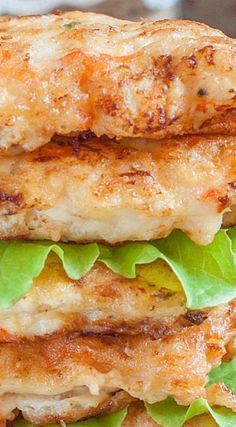 two chicken patties stacked on top of each other with lettuce and cheese