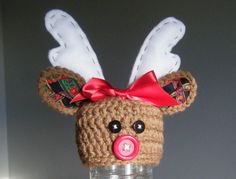 a crocheted deer head with red bow on it's ears and nose