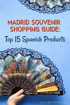 a hand holding an ornate fan with the words madrid souvenir shopping guide top 15 spanish products