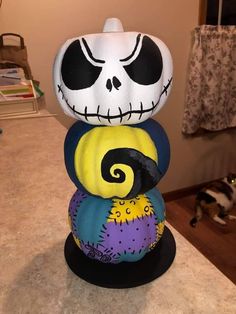 a stack of halloween rocks with jack skellings painted on them