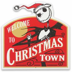 a welcome sign for christmas town with a skeleton holding a santa hat on it's head