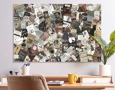 a wall covered in lots of different types of paper on top of a wooden table