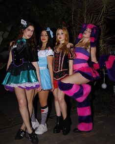 three women dressed in costumes posing for the camera