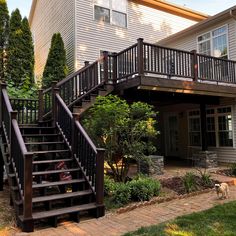 a house with stairs leading up to the front door and back porch area in the foreground