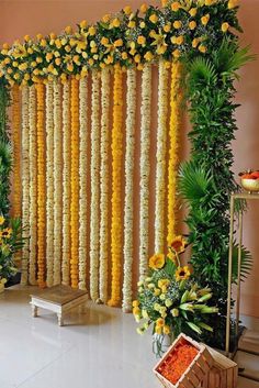 an arrangement of flowers and greenery on the wall