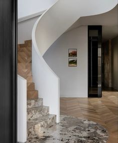 a spiral staircase in a house with marble floors