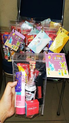 a person is holding up some items in a clear bag on a table with other items