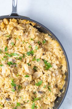 a skillet filled with rice and mushrooms