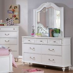 a white dresser and mirror in a room