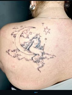 the back of a woman's shoulder with a moon and stars tattoo on it