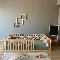 a baby's room with a crib and toys on the floor in front of it