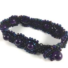 Amethyst Beads set in black macrame with Blue Iris beads Adjustable Amethyst Beads For Jewelry Making, Purple Beaded Bracelets With Black Beads As A Gift, Black Beaded Amethyst Jewelry, Adjustable Black Amethyst Jewelry, Purple Bohemian Jewelry With Black Beads, Adjustable Purple Bracelets With Black Beads, Bohemian Purple Jewelry With Black Beads, Adjustable Purple Bracelet With Black Beads, Black Amethyst Gemstone Beaded Bracelets