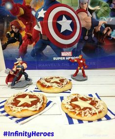 captain america mini pizzas are sitting on a table with toy figurines in the background