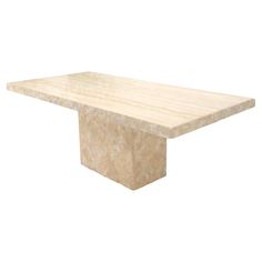 a white marble table with a square base on it's end, against a white background