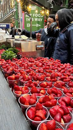 many baskets of strawberries are on the table