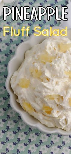 a white bowl filled with fruit salad on top of a blue and white table cloth