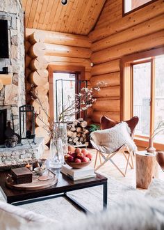 a living room filled with furniture and a fire place in front of a stone fireplace