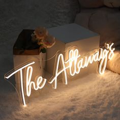 the alwayss light up sign with flowers on it