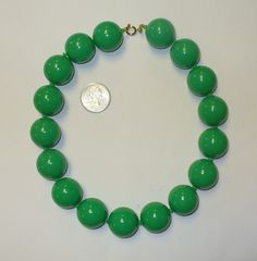 "Super Duper bright green go-go choker. The plastic beads measure about 1\" each. The beads are NOT individually knotted. The necklace measures 17\" long. Nice vintage plastic beads. Please check out all of our great vintage deadstock jewelry and accessories in our ETSY store SHOPHULLABALOO. Thanks!! The Hullabaloozers Did you know most of our items are also available for wholesale??? Message for details. Cheers!" Retro Green Beaded Necklace For Gift, Retro Green Beaded Necklaces, Green Plastic Round Bead Jewelry, Vintage Large Green Beads, Vintage Plastic, Super Duper, Jewelry And Accessories, Plastic Beads, Beaded Choker