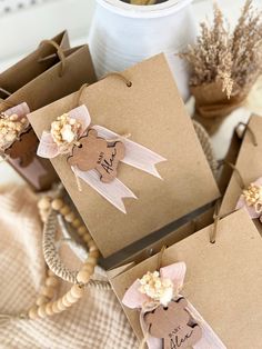 some brown bags with tags and flowers on them