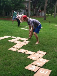 two children playing with wooden blocks in the grass