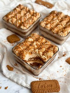 four desserts sitting on top of a white cloth