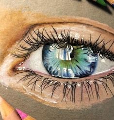 a drawing of an eye with colored pencils