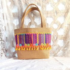 Immerse yourself in the summer spirit with our magnificent hippie boho burlap basket tote bag in vibrant purple and yellow. This colorful and cheerful accessory is perfect for sunny days, beach walks and summer getaways. In addition to being trendy, this bag embodies the boho spirit with its natural burlap texture, its ethnic fabric and its ribbon and braid ornaments. Its large capacity and natural cotton canvas lining allow you to easily carry everything you need during your summer outings. Let Brown Bohemian Bucket Beach Bag, Bohemian Bucket Beach Bag For Beach Season, Bohemian Bucket Beach Bag, Bohemian Woven Beach Bag For Daily Use, Bohemian Straw Tote Bag For Daily Use, Bohemian Basket Shoulder Bag For Beach Season, Bohemian Jute Bag For Market, Bohemian Jute Bag For Summer, Bohemian Multicolor Bucket Straw Bag